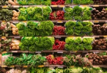 Close-up view of a produce section in a grocery store, showcasing the variety of fresh vegetables available to those facing food insecurity.