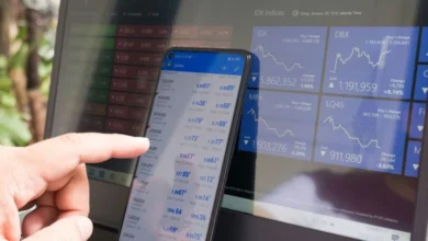 Day trading market analysis on smartphone and stock dashboard